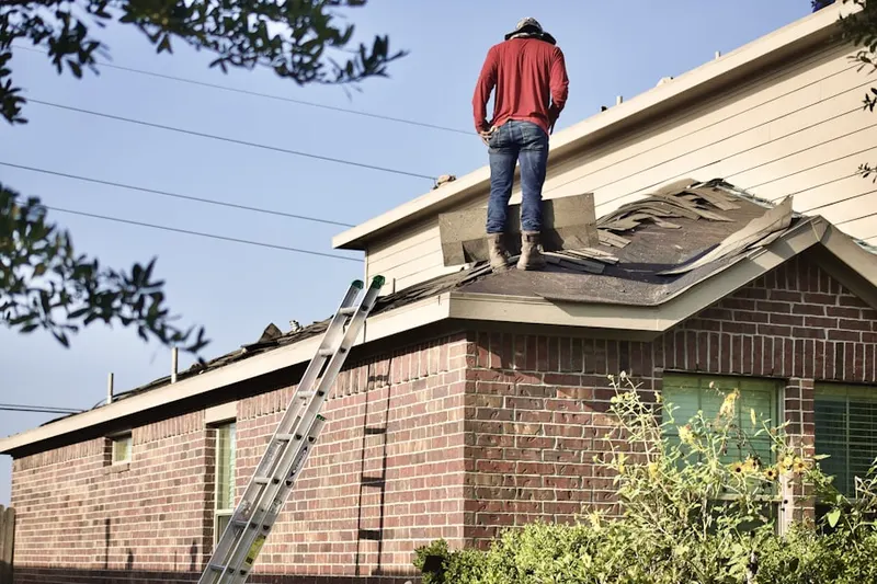 Professional roofer working on a residential roof in Mansfield Depot